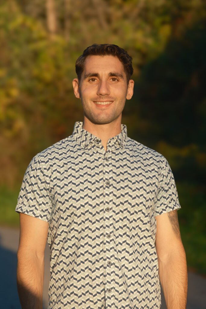 Portrait of Simon Erlich, relational and IFS-informed counsellor, set against a soft, nature-inspired backdrop for online sessions across BC